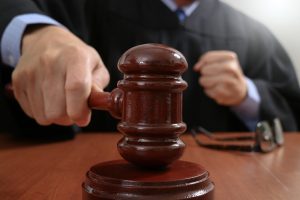 .Male judge in a courtroom striking the gavel